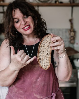 Vanessa Kimbell holding slice of sourdough bread