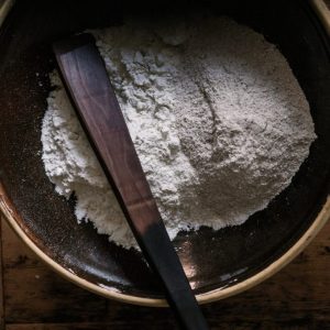 Flour in a dark brown bowl