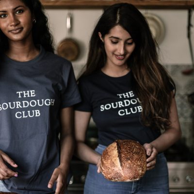 Two students at the sourdough school holding bread