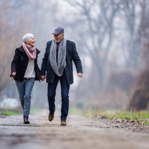 Carefree senior couple having fun in winter day at the park.
