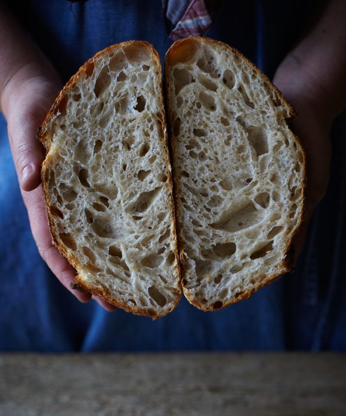 Loaf of sourdough split in half to show texture and holes