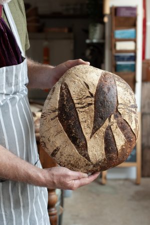 Holding a Loaf of healthy bread 