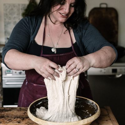 Dr Vanessa Kimbell Handling sourdough dough, highlighting the slow fermentation process and the gut-brain connection benefits of sourdough for mental well-being.