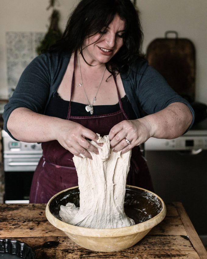 Dr Vanessa Kimbell Handling sourdough dough, highlighting the slow fermentation process and the gut-brain connection benefits of sourdough for mental well-being.
 